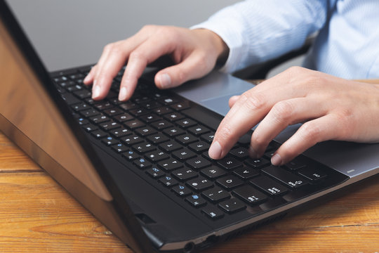 Businesswoman's hands typing on laptop keybord. 