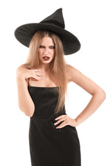 Fototapeta premium Beautiful woman dressed as witch for Halloween on white background