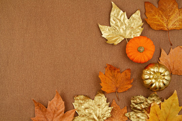 Flat lay autumn composition with fall yellow and golden leaves and pumpkins