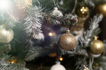 Close-up of a beautifully decorated Christmas tree with garlands and toys before the holiday