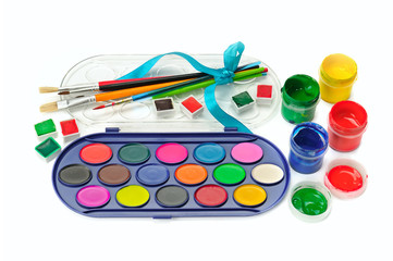 Watercolor paints and brushes isolated on white background.