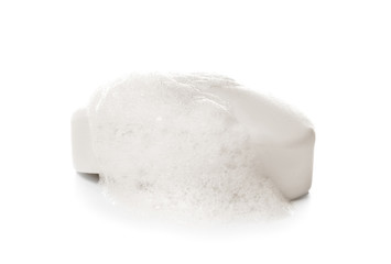 Soap bar with foam on white background