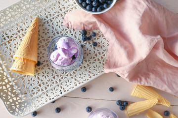 Tray with tasty blueberry ice cream on wooden table