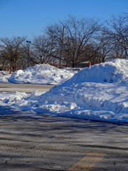Drifts left from snow removal for parking purposes.