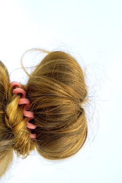 Long medium blond hair arranged in a classic knot.