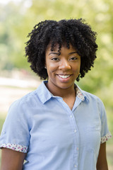 Happy African American woman with curly hair.