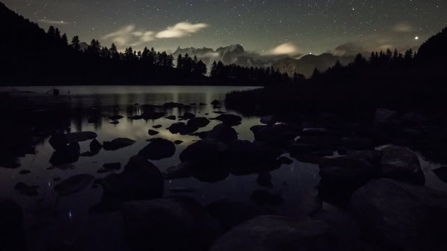 Alpine lake timelapse under night sky, Arpy, La Thuile, Alps, Italy, Europe