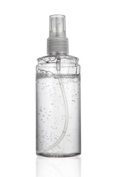 Transparent bottle of alcohol gel for cleaning screen and monitor display isolated on white