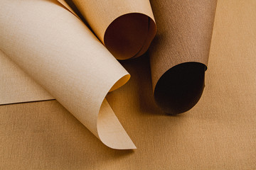Abstract backgroud of rolled textured paper sheets of different shades