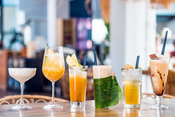 Selection of alcoholic and milkskake cocktails at bar background.