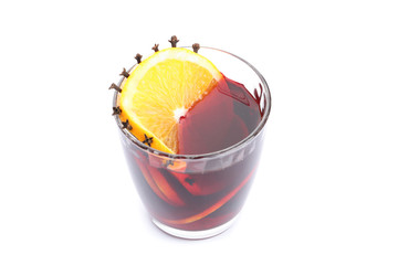 Glass of tasty mulled wine with orange isolated on white background