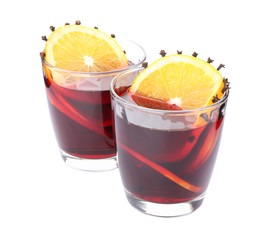 Glasses of tasty mulled wine with orange isolated on white background