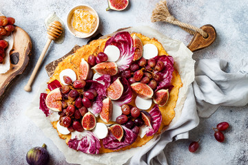 Cauliflower pizza crust with figs, radicchio, goat's cheese and red grapes. Vegetarian, grain free, low carb, gluten free diet concept