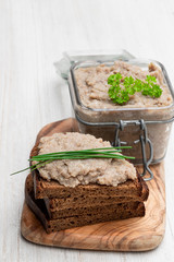 Forshmak paste from herring with herbs on white wooden table