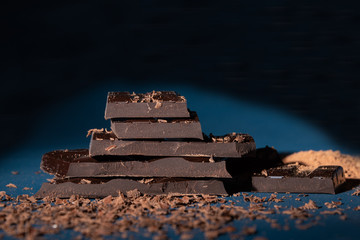 Pieces of dark chocolate, chocolate chips and cocoa powder.