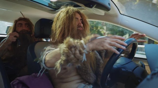 Prehistoric wild furious taxi driver wearing animal fur driving car with anger. Archaic humans and modern life in city. Evolution degradation concept.