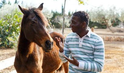 Farmworker carrying horse