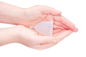 Eco-friendly hypelergenic gynecological silicone menstrual cup for women. Hygienic silicone bowl for collecting menstrual blood in the hands on a white background. Save money.
