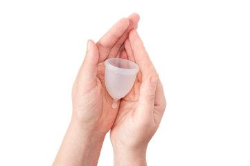 Eco-friendly hypelergenic gynecological silicone menstrual cup for women. Hygienic silicone bowl for collecting menstrual blood in the hands on a white background. Save money.