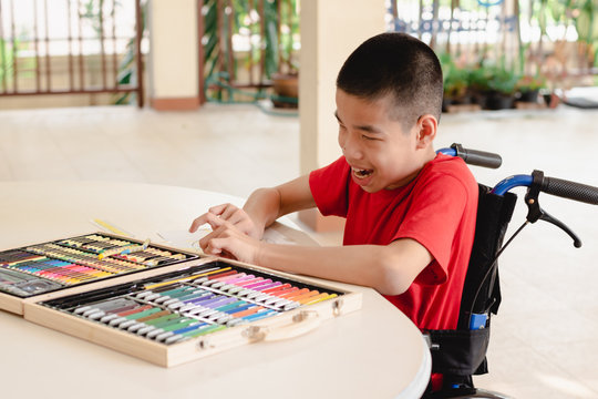 Asian Disabled Child On Wheelchair Coloring Art Work,The Skills To Practice Muscle Development,Special Children's Lifestyle,Life In The Education Age Of Special Need Kids,Happy Disability Kid Concept.