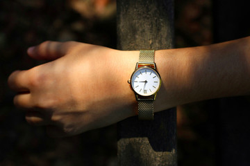 Young girl with a gold watch and quartz on her wrist.