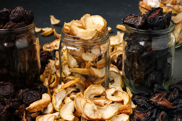 Homemade dried apples, plums and pears in glass jars, Horizontal orientation, Closeup