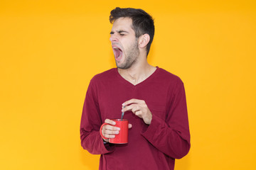 isolated young man yawning or waking up in color background