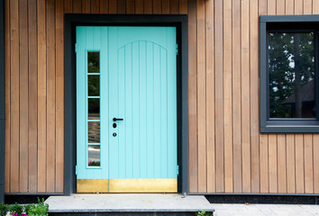 Beautiful entrance blue door and window of the house