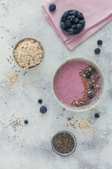 Obraz na płótnie Canvas Pink yogurt smoothie bowl made with fresh blueberry and seeds