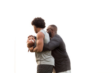 American Football coach training a young athlete.