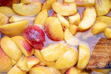 peach jam. peaches with sugar syrup. above. looking above. fruit background backdrop.