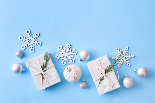 Flat Lay Christmas Border With Silver Christmas Balls And Gift Box On A Blue Background