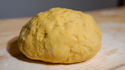 Kneaded yellow dough of eggs and white wheat powder flour. dough for pastry and bread. Dough ingredients concept