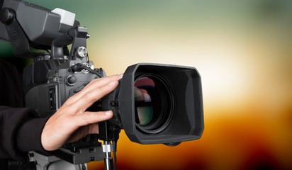 Cameraman with his camera on white background