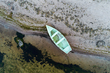 Aerial view of an old wooden boat at the coastline of the Baltic sea. (high ISO image)
