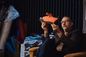 Boss of boot service is thinking about new design project.