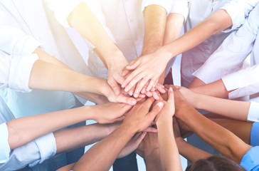 Close-up view of group of people stacking hands