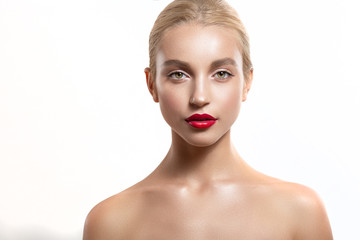 Beautiful blonde girl with professional makeup and red lipstick. Her hair was in a bun.