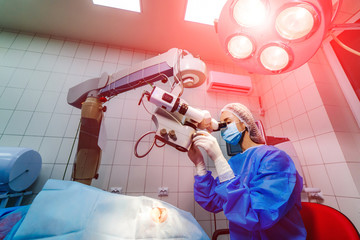 Surgeon with operating system of laser vision correction in the operating room. Ophthalmology....