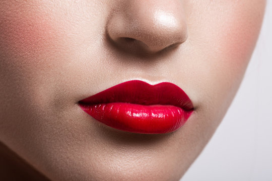 perfect female lips closeup. Red lipstick and clean skin.