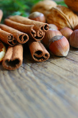 Top border of festive spices and baking ingredients on rustic wooden background. Christmas, New year background. Copy space.