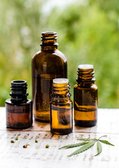 Cannabis oil or CBD oil cannabis extract, Hemp oil. Premium marijuana products. Medical marijuana cannabis cbd oil in a bottles with marijuana leaf.  Copy space