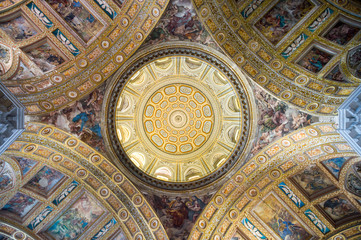 Fototapeta na wymiar Abstract view of sun streaming onto the frescos of the baroque cupola of the Gesù Nuovo in Naples, Italy