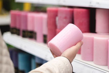 Buyer is choosing a candles in a store.