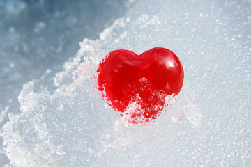 Red heart in ice. Close-up. Background. Texture.