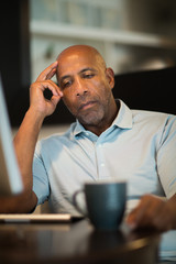 Mature African American man upset and looking concerened.