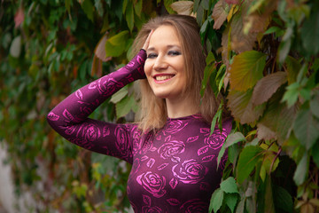 pretty girl in tiger costume pose in Wild grape leaves