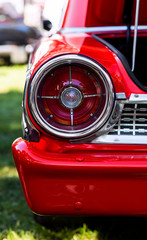 Fototapeta na wymiar brake light of vintage car, bumper of retro red automobile