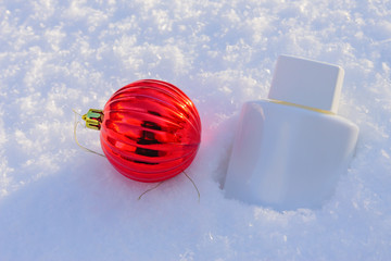cream after shaving on the snow next to christmas decoration