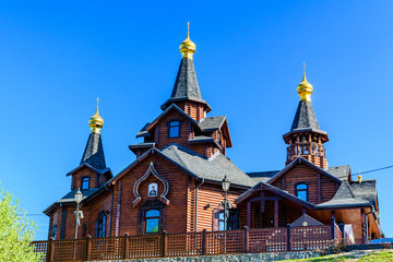 Fototapeta na wymiar The temple in honor of the icon of the Mother of God Joy and Consolation in Kharkov, Ukraine. Traditional wooden orthodox church